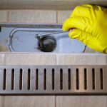 plumber removing clogged shower drain