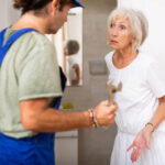 elderly woman talking with plumber